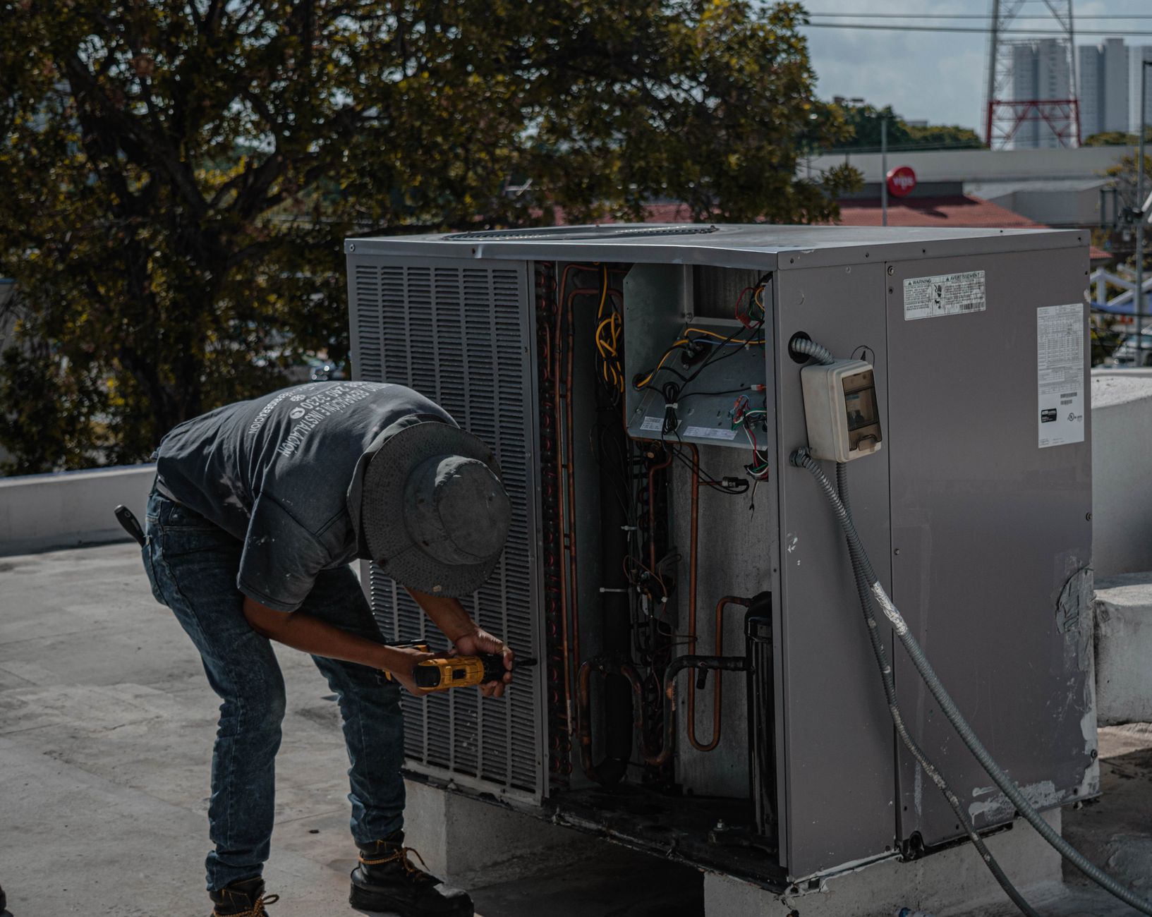 HVAC technician performing air conditioner tune-up
